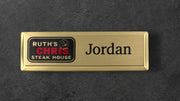 Gold name tag with 'Ruth's Chris Steak House' logo and 'Jordan' text on a gold background
