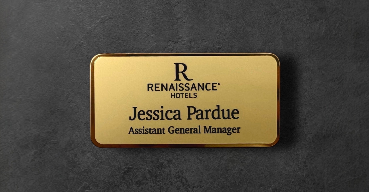 Gold name tag with 'Renaissance Hotels' logo and text 
