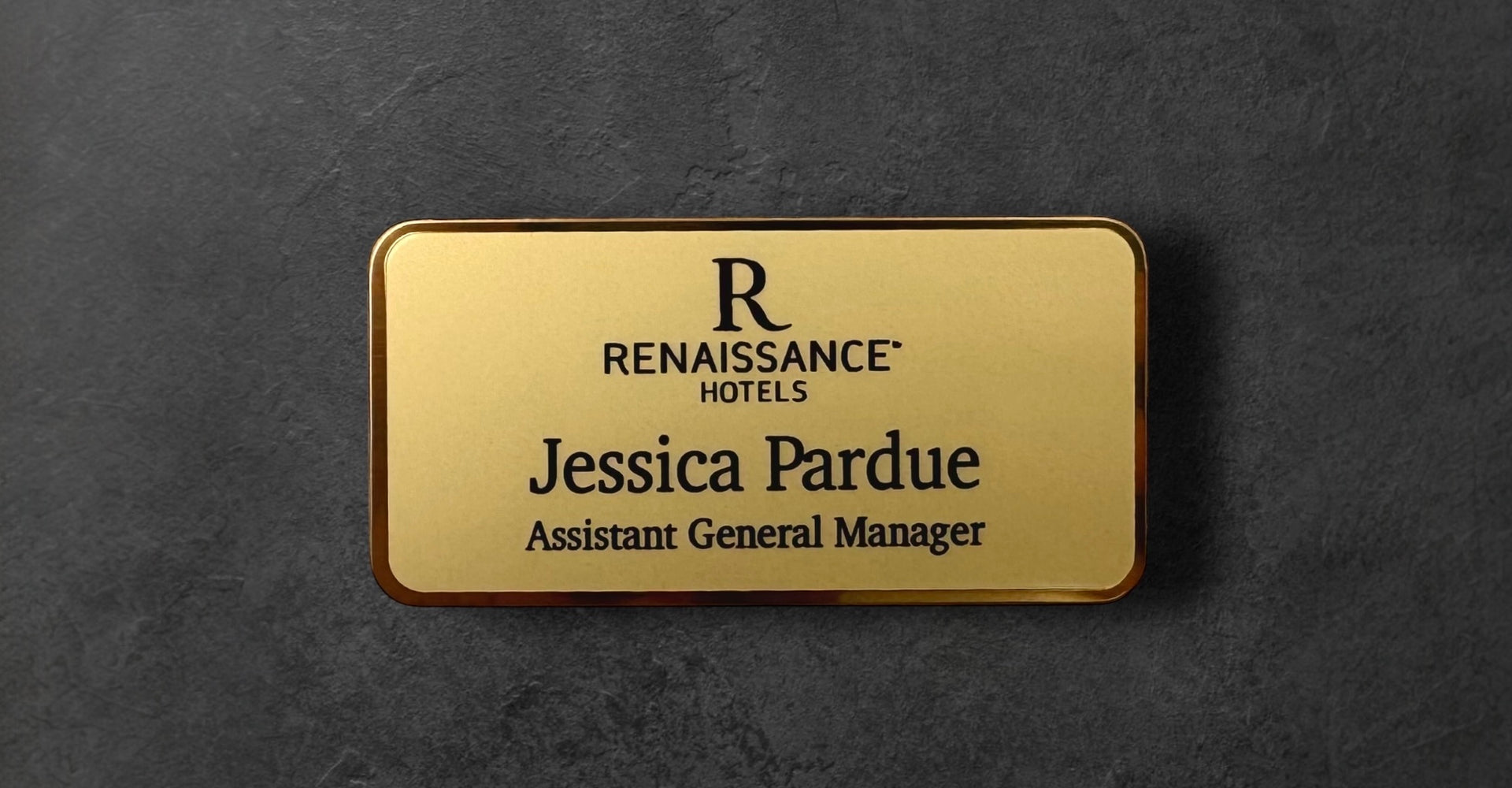 Gold name tag with 'Renaissance Hotels' logo and text 