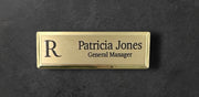 Gold metal beveled name tag with a brushed gold metal face, with logo, name and title