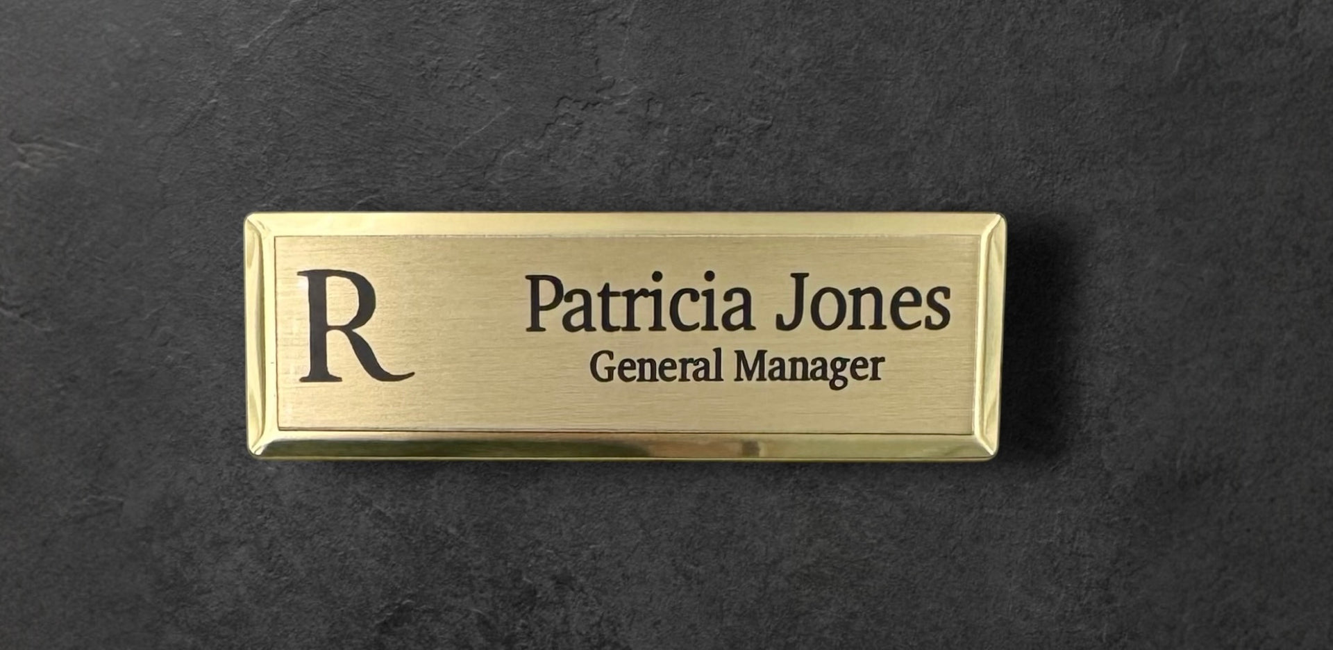 Gold metal beveled name tag with a brushed gold metal face, with logo, name and title