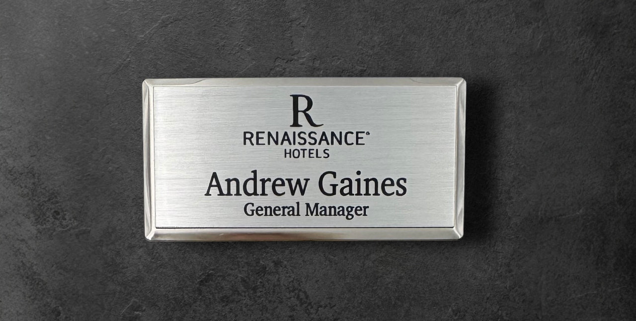 Silver metal beveled name tag with a brushed silver metal face, with logo, name and title, 1.5" x 3"