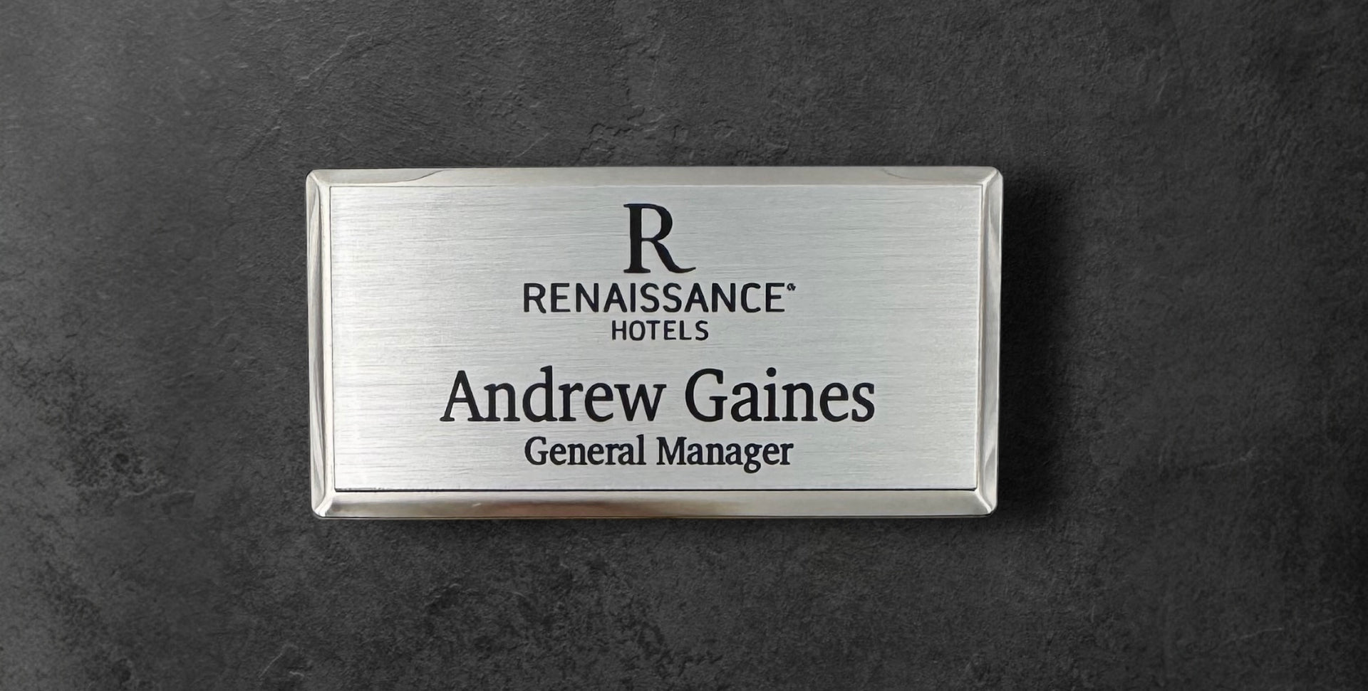 Silver metal beveled name tag with a brushed silver metal face, with logo, name and title, 1.5" x 3"
