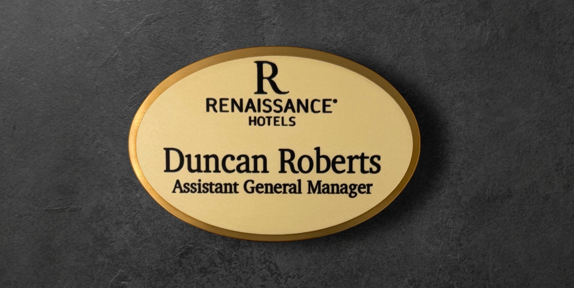 Gold Oval name tag with 'Renaissance Hotels' logo and text 