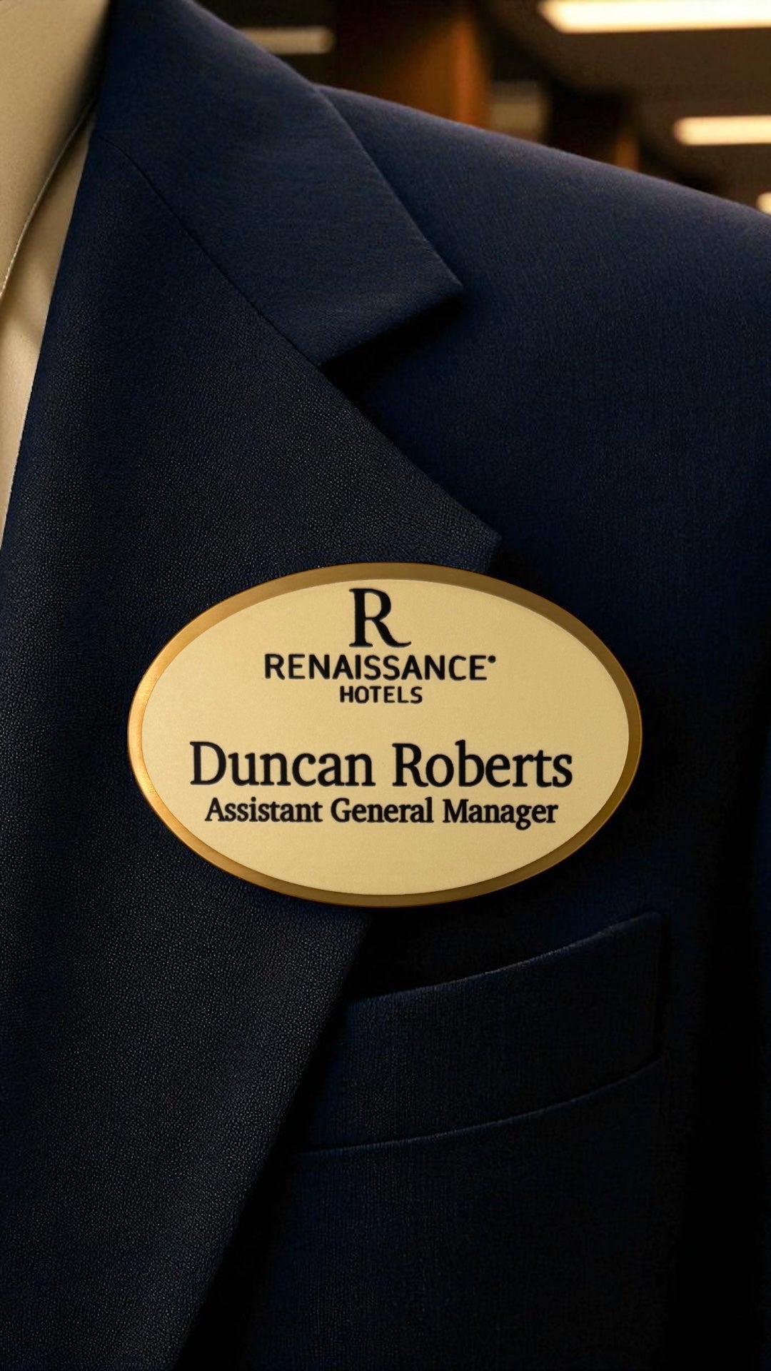 Navy blazer with a Renaissance Hotels name tag on a blurred background