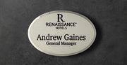 Renaissance Hotels name tag in silver metal with logo on top, name and title underneath